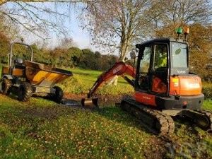 image of a digger building a pond